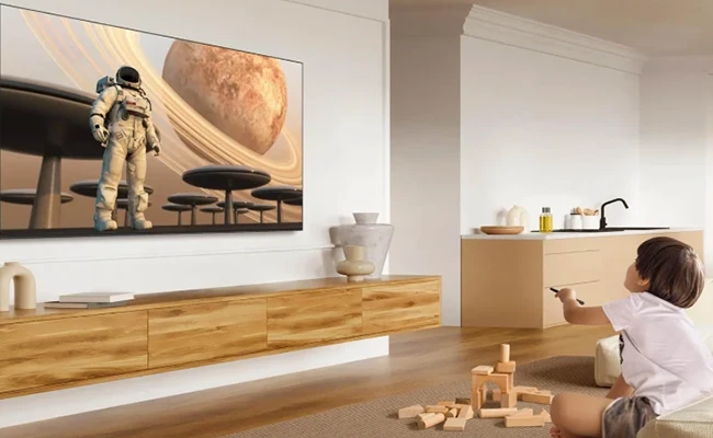 کودک در حال تماشای برنامه در تلویزیون tcl 65c635